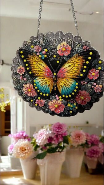 黒をバックに色とりどりの蝶と花のモチーフのダイヤモンドビーズアート(完成品)