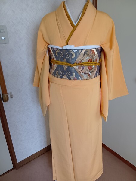 一つ紋いり色無地 単衣 蜜柑色 未使用 フォーマル 慶事 賀寿 結婚式 お宮参り 佳き日 お嫁にいかれるお嬢様にも
