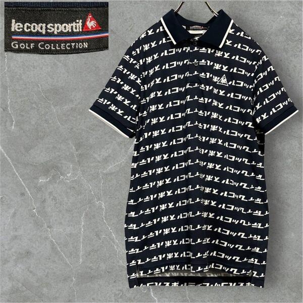 Le Coq Sportif ゴルフコレクション カタカナ総柄 ポロシャツ ルコック カタカナ総柄 ポロシャツ ネイビー メンズM 黒 トップス
