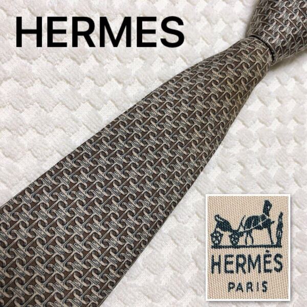 HERMES エルメス ネクタイ H型金具 シェーヌダンクル風金具 総柄 シルク100% フランス製 ブラウン ベージュ系