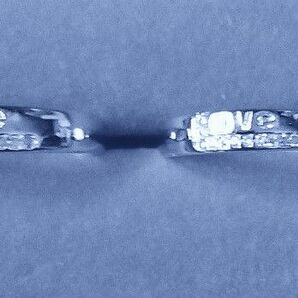 シルバーカラーペアリング Love文字の下にL型をジルコン風の細かな石で包むデザイン サイズ14号20号 刻印は数字で詳細不明