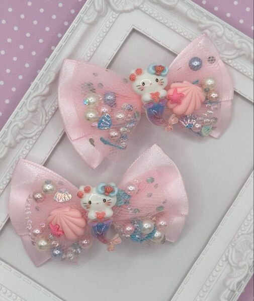 ハンドメイド ヘアクリップ リボン キッズ ベビーマーメイド ハローキティ パステルピンク シャカシャカリボン