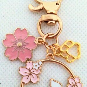 ピンクの桜の花と肉球と透かし模様のピンクの桜と桜模様の白い猫キーホルダー