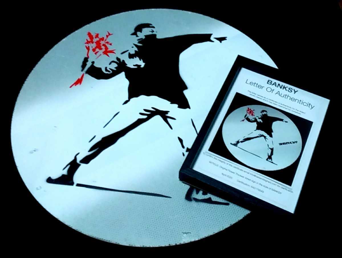 Banksy's road sign Flower Thrower road sign.A work discovered in Bristol, England around 2009■Contains the words Nuneaton Sign■, artwork, painting, graphic