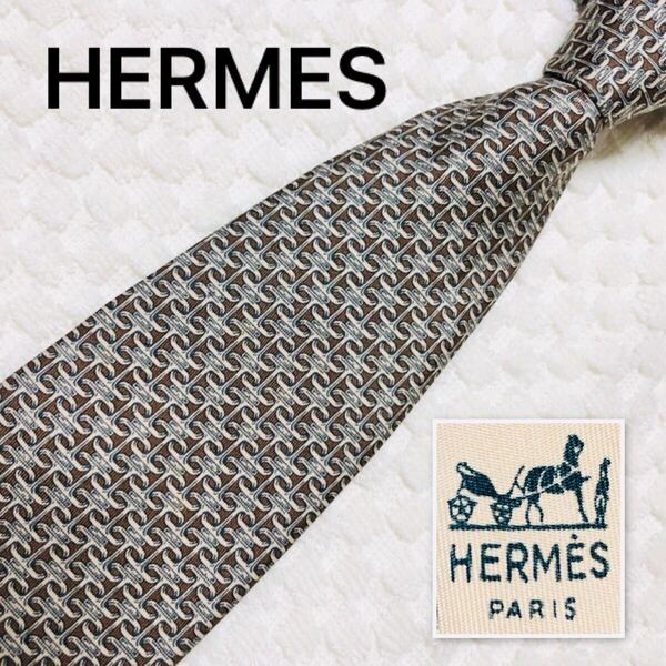 ■美品■HERMES エルメス ネクタイ シェーヌダンクル風 H柄金具 総柄 シルク100% フランス製 652 TA ブラウン×ベージュ×グレー