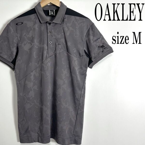 《美品》OAKLEY オークリー 半袖 スカル ロゴ刺繍 総柄 ポロシャツ ゴルフウエア グレー系 M
