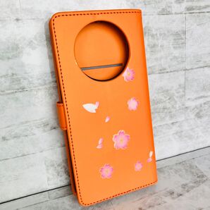 【AQUOS R8 pro】手帳型ケース 桜が舞うシンプルデザイン オレンジ カードお札収納 スタンド機能 横置き ビタミンカラー