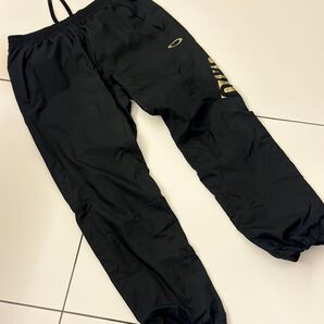 オークリー ウィンドブレーカー パンツ ブラック ゴールド ロゴ ナイロン XL スポーツウェア