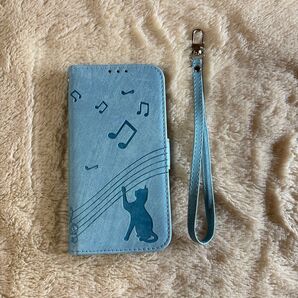GALAXY A23 5G用 手帳型ケース 水色 音符と猫柄 ストラップ付き