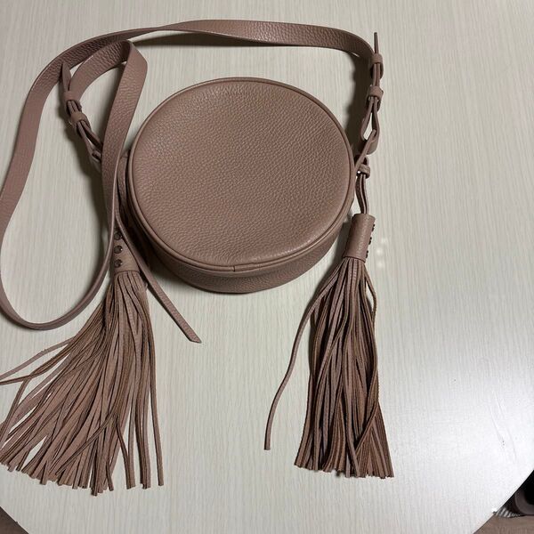 ALLSAINTS円形ショルダーバッグ タッセル付き