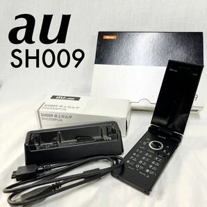 【ジャンク品】au ケータイ電話 SH009 黒 パカパカ ミッドナイトブラック 通電不可 卓上ホルダ付き 部品取り 現状販売品 [OTFM-258の画像1