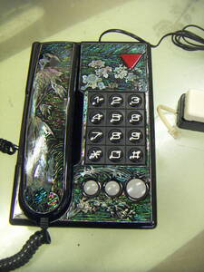 [ telephone machine ]** mother-of-pearl pattern entering desk telephone **