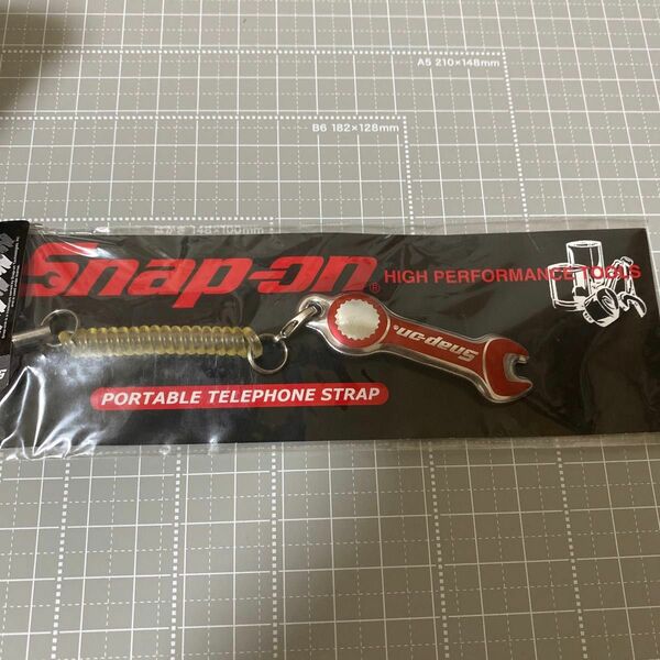 Snap-on portable telephone strap