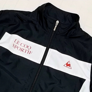 【デサント製】◎ le coq sportif ルコックスポルティフ/ 長袖 プリントロゴ ウィンドジャケット 裏地あり　SIZE： O　ブラック