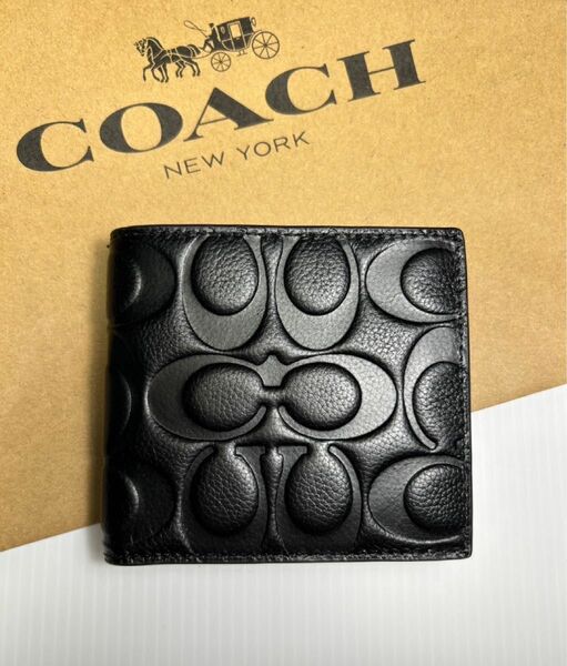 新品　未使用　コーチ　COACH シグネチャー型押しエンボスド　レザー　二つ折り財布　箱、紙袋付き
