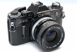 Canon キャノン 昔の高級一眼レフカメラ AE-1（黒）ボディ +（純正FD 28mm単焦点レンズ付）作動品 （鳴き無し）（腐食無し）