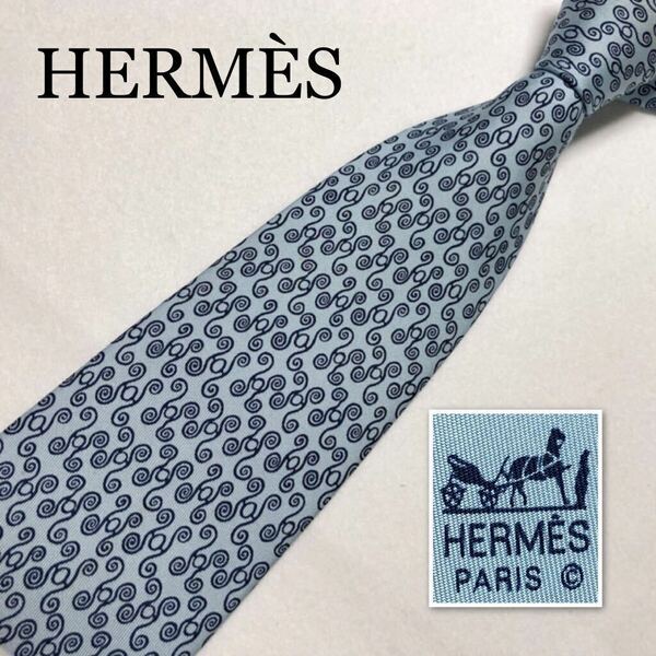 HERMES エルメス　ネクタイ　H柄　渦巻き　総柄　シルク100% フランス製　ライトブルー　ビジネス