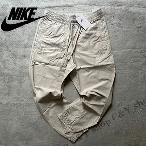 格安送料 Lサイズ 新品 NIKE ナイキ スポーツウェア カフパンツ トラックパンツ コットン ウーブン パンツ ナイロン ジョガー aDD5311-072の画像1