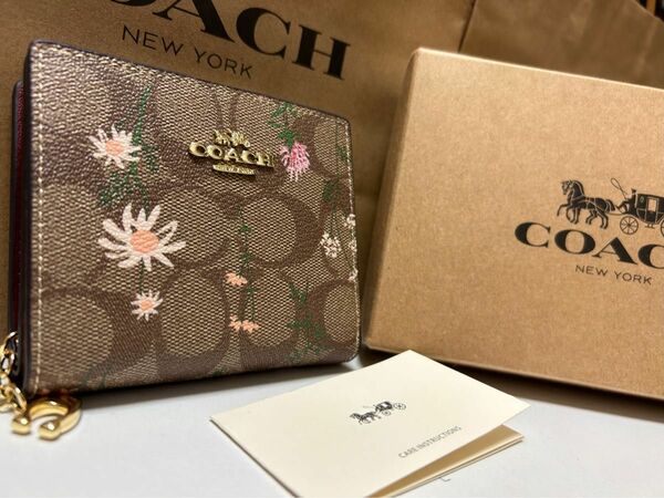 11 新品未使用 coach コーチ 二つ折り ミニ財布 花柄 シグネチャー