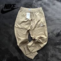 格安送料 Mサイズ 新品 NIKE ナイキ スポーツウェア カフパンツ トラックパンツ コットン ウーブン パンツ ナイロン ジョガー aDD5311-247_画像1