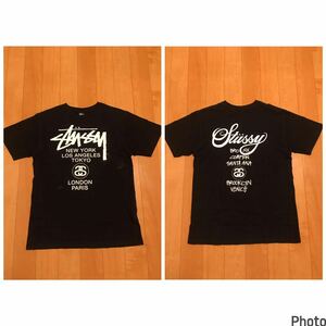 良品☆stussy／ステューシー　メンズサイズL 半袖ブラックTシャツ　両面BIGプリント・ワールドツアー　シャネルロゴ&ストックロゴ他.都市名