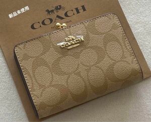 新品 COACH コーチ 二つ折り財布 シグネチャー　がま口　キスロック